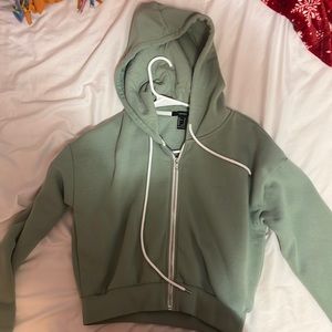 this is basically brand new only worn once or twice light green zip up!